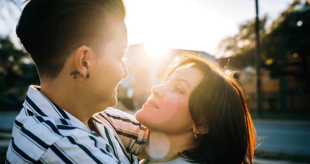 Two woman standing close with each other.